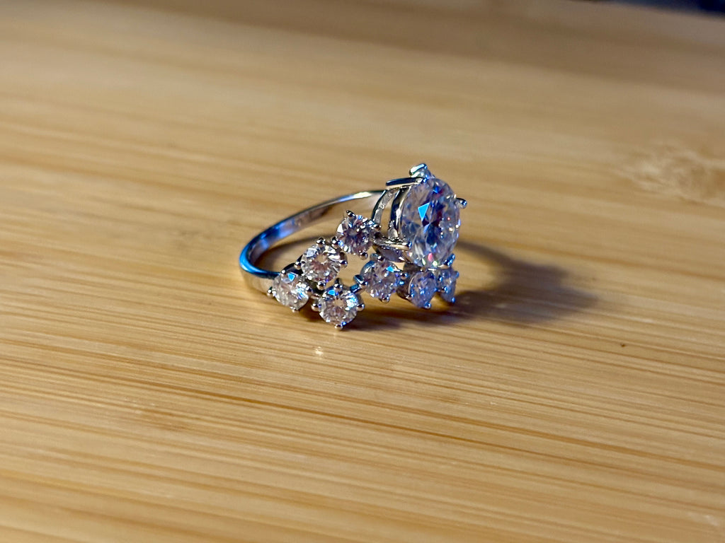 Moissanite ring. The “Moissanite Galaxy” ring features a 3ct certified Moissanite amid a 4cttw Moissanite constellation  - a 7cttw ring!
