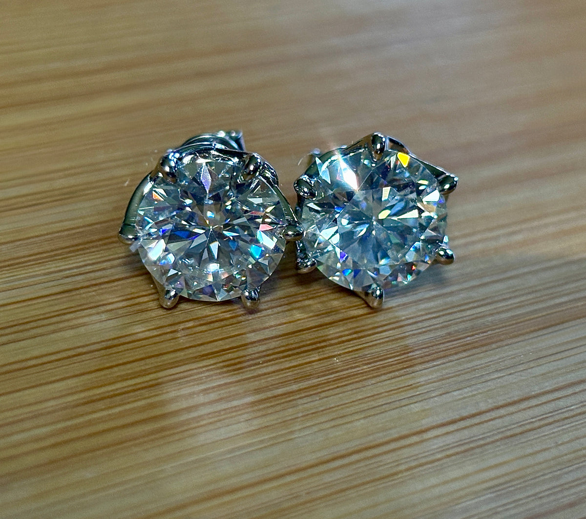 A 10ctw pair of double certified Moissanite studs in lotus-shaped sterling silver baskets!