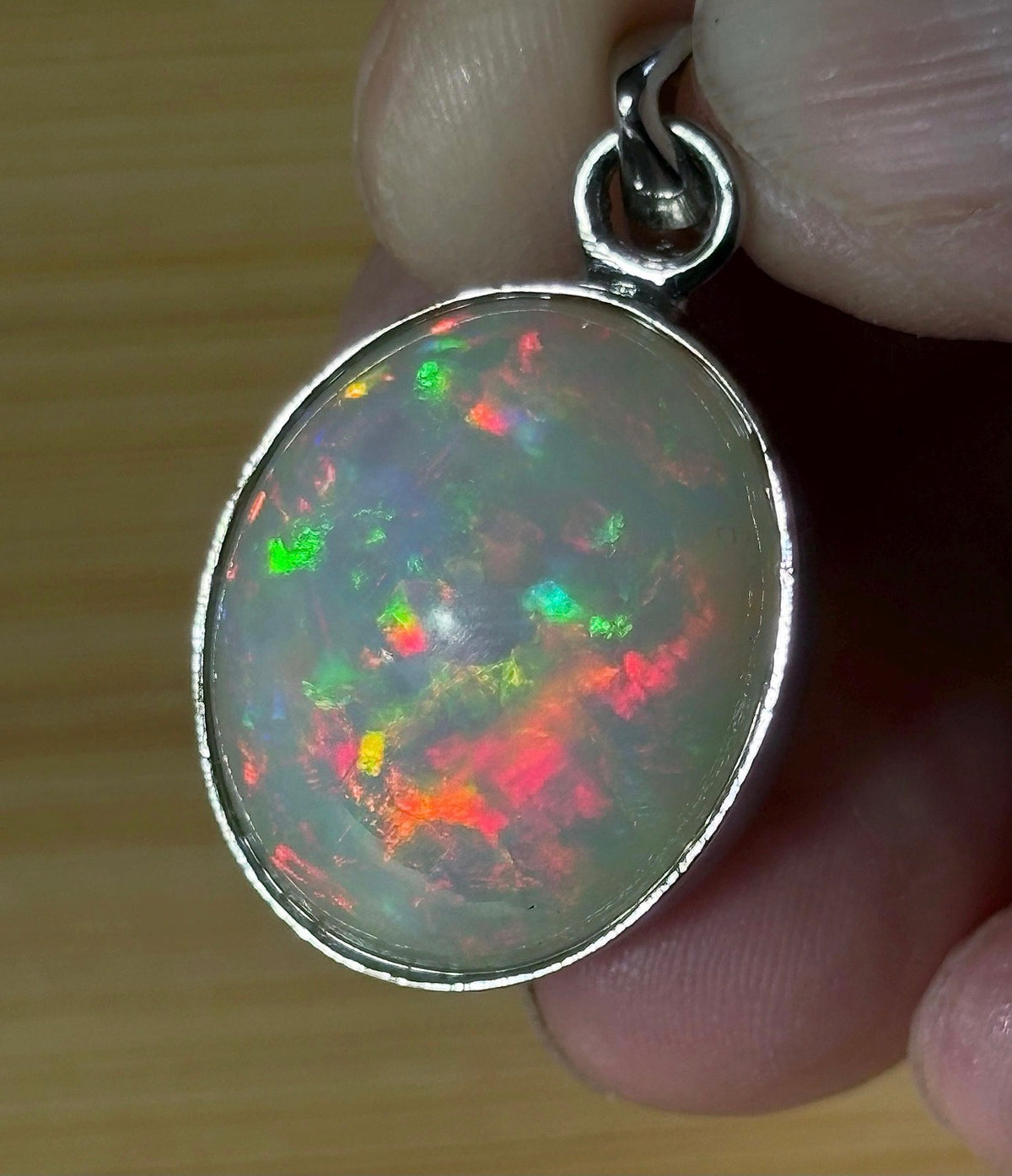 A 17.28ct AAA grade Ethiopian opal pendant with multi-patterned fire and beautiful play of color, hand-picked by Hand Knotted Jewelry!