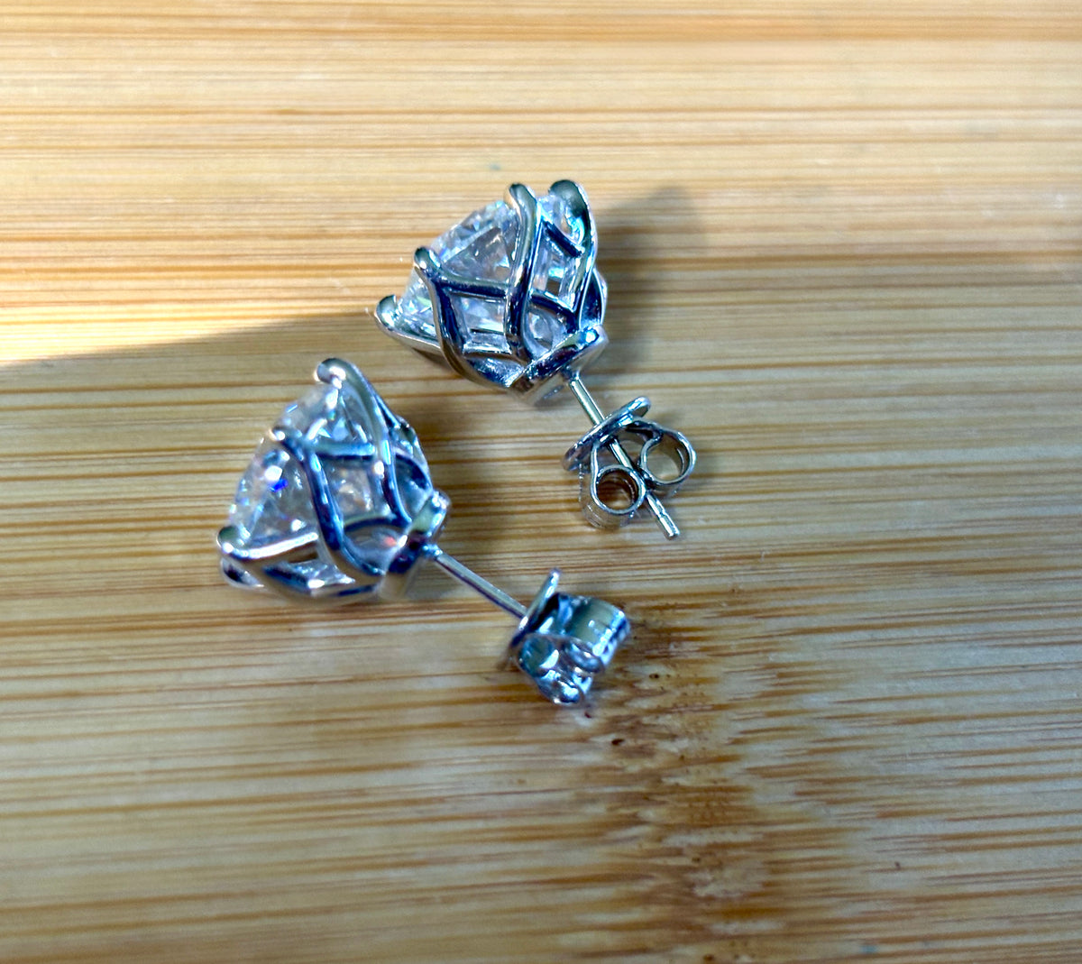 A 10ctw pair of double certified Moissanite studs in lotus-shaped sterling silver baskets!
