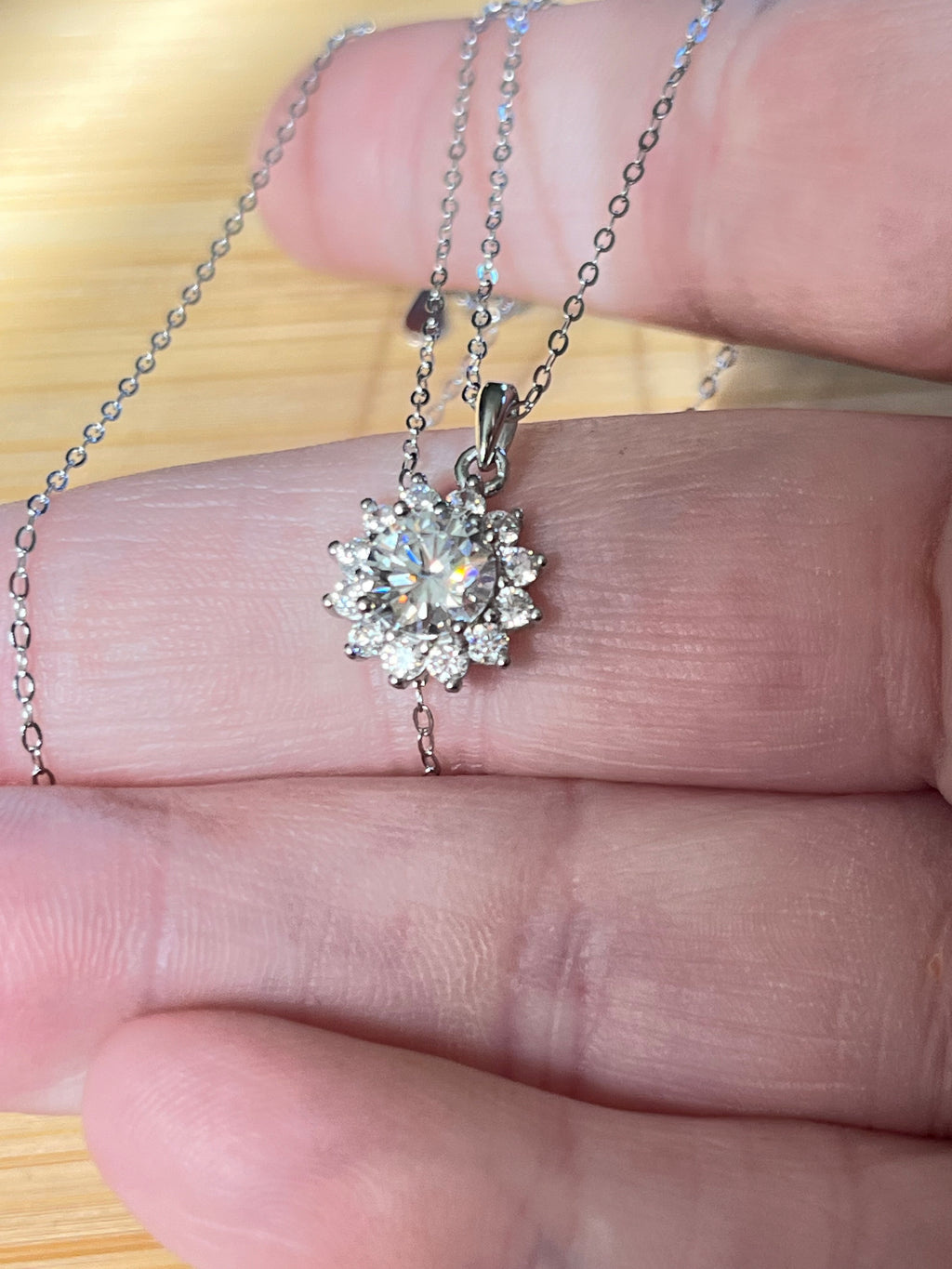 Moissanite necklace. A 1ct or 3ct Moissanite in a halo of sparkling white zircons (I call it the “Sunflower” pendant)! In sterling silver and 18k!
