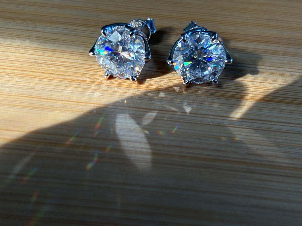 A 10ctw pair of double certified Moissanite studs in lotus-shaped sterling silver baskets!