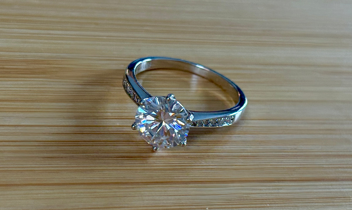 Moissanite ring. A delicious 3ct certified Moissanite solitaire with tapered shoulders and pavé-set white zircons in sterling and 18k gold!