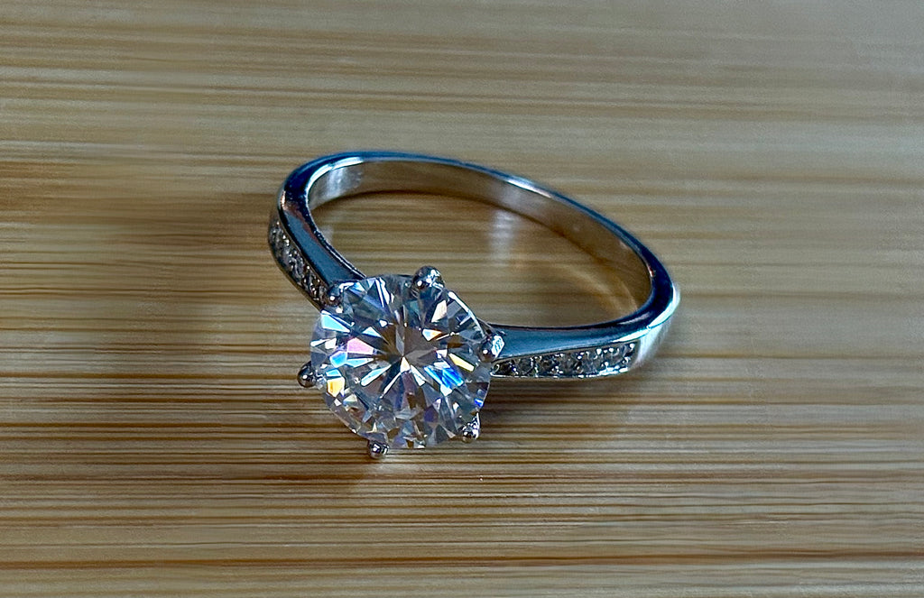 Moissanite ring. A delicious 3ct certified Moissanite solitaire with tapered shoulders and pavé-set white zircons in sterling and 18k gold!