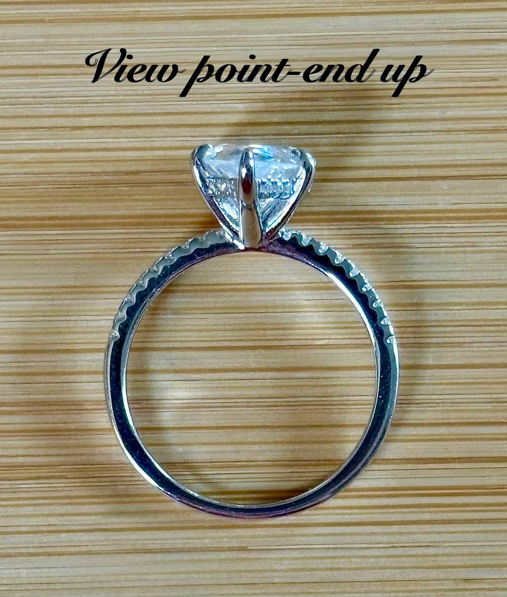 A certified 5ct pear-cut Moissanite solitaire in 925 sterling OR 935 Argentium silver with 18k, with pavé-set Moissanite shoulders and Moissanite hidden halo!