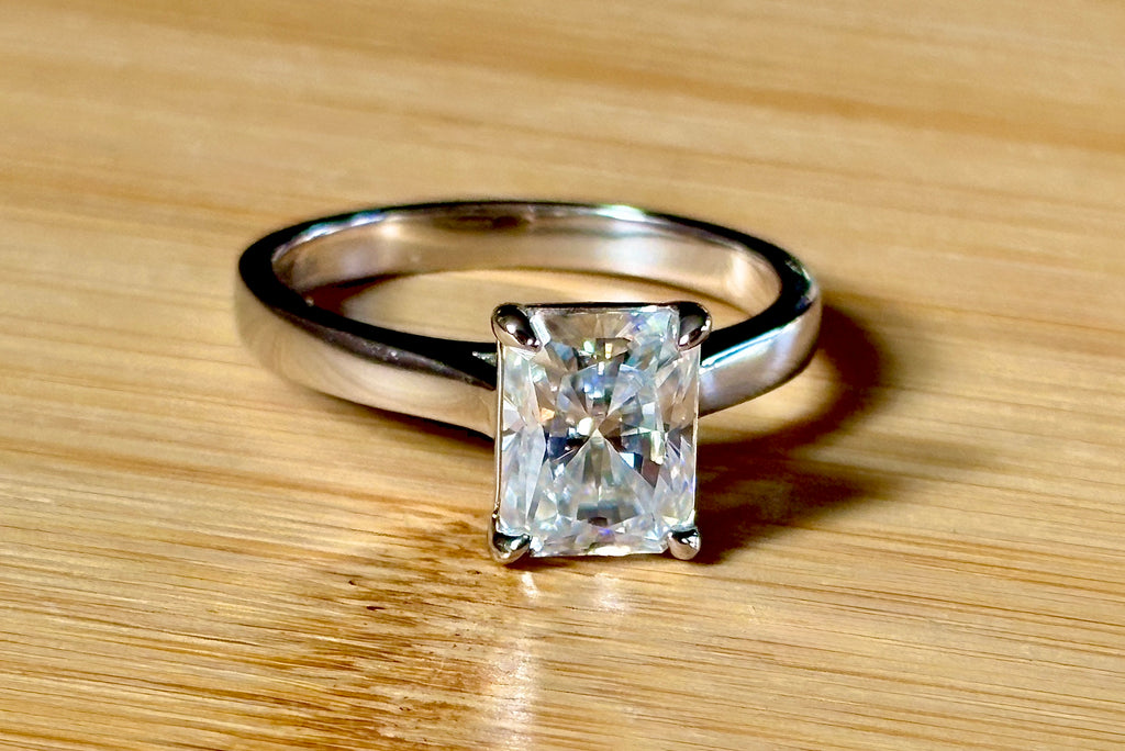 A certified Moissanite 3ct radiant solitaire! An UBER flashy, ULTRA classy, contemporary and chic radiant-cut engagement ring!