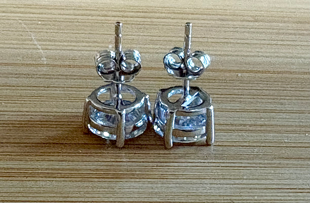 Moissanite earrings. A delicate certified 2cttw pair of 3-prong or 4-prong round brilliant Moissanites in 18k gold-embraced sterling silver baskets! Classic!
