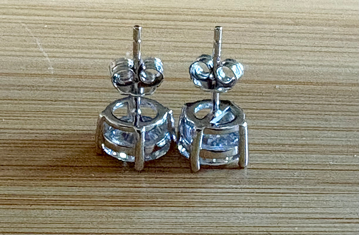 Moissanite earrings. A delicate certified 2cttw pair of 3-prong or 4-prong round brilliant Moissanites in 18k gold-embraced sterling silver baskets! Classic!