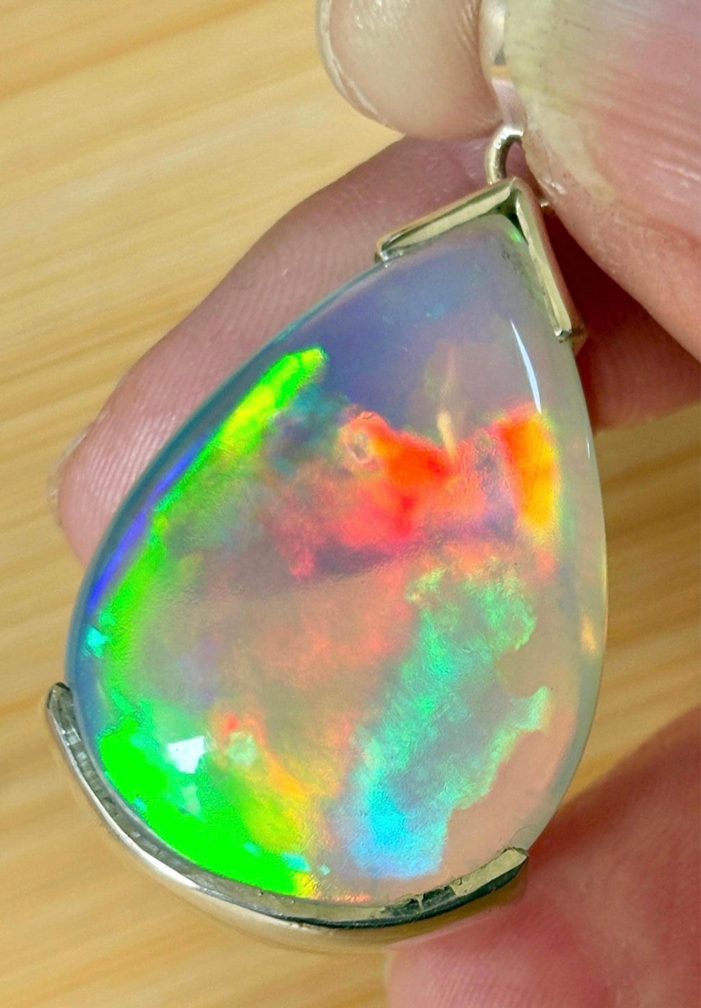 The “After the Storm” Ethiopian opal pendant, 39.18ct with rare “rolling” fire and spectacular play of color! **Collector’s grade** AAAA++