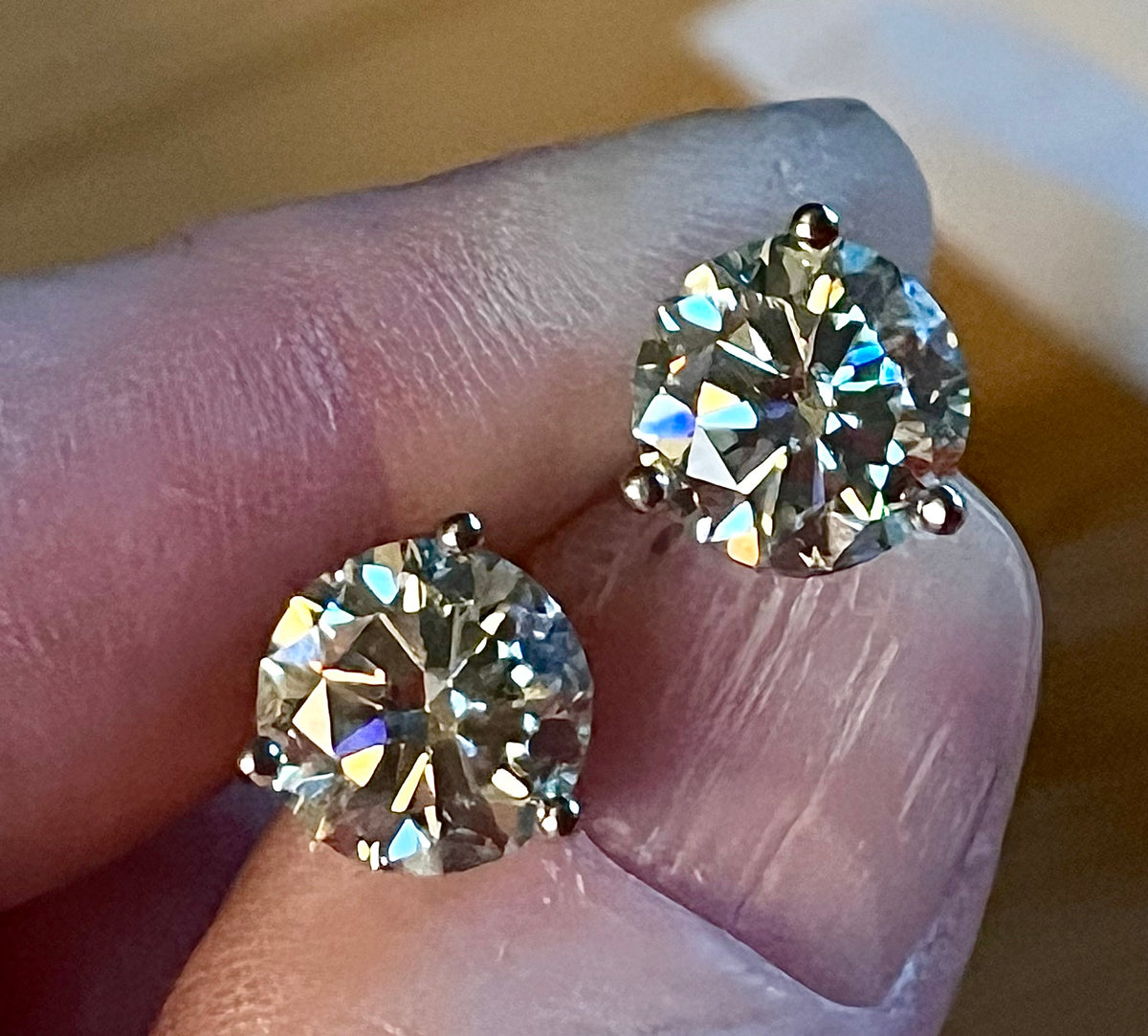Moissanite earrings. A delicate certified 2cttw pair of 3-prong or 4-prong round brilliant Moissanites in 18k gold-embraced sterling silver baskets! Classic!