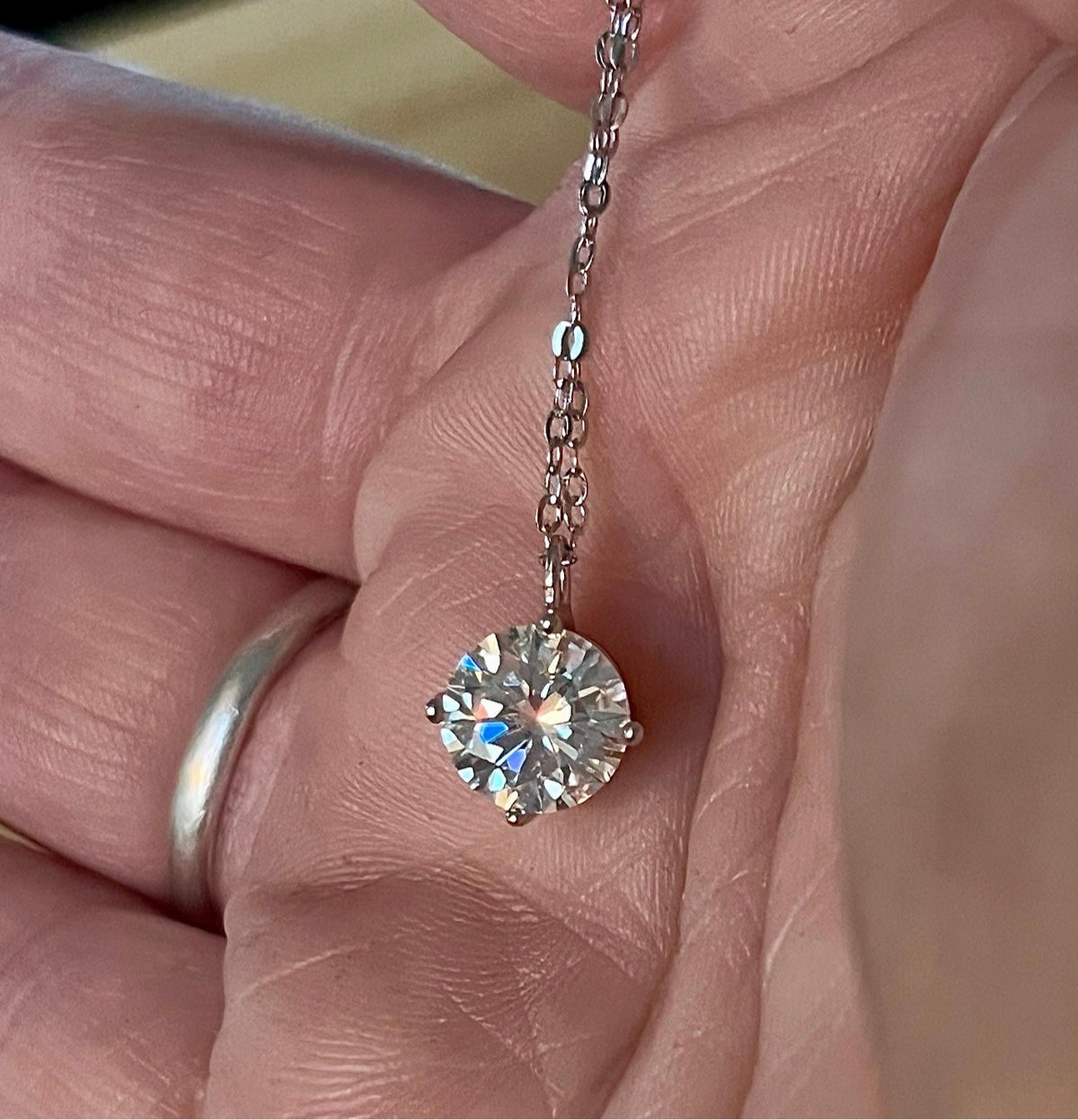 2ct Moissanite solitaire necklace. A 2ct “Floating Moissanite” in sterling silver creates the illusion of being suspended by nothing more than spider silk!