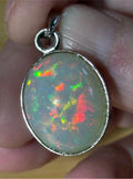 A 17.28ct AAA grade Ethiopian opal pendant with multi-patterned fire and beautiful play of color, hand-picked by Hand Knotted Jewelry!