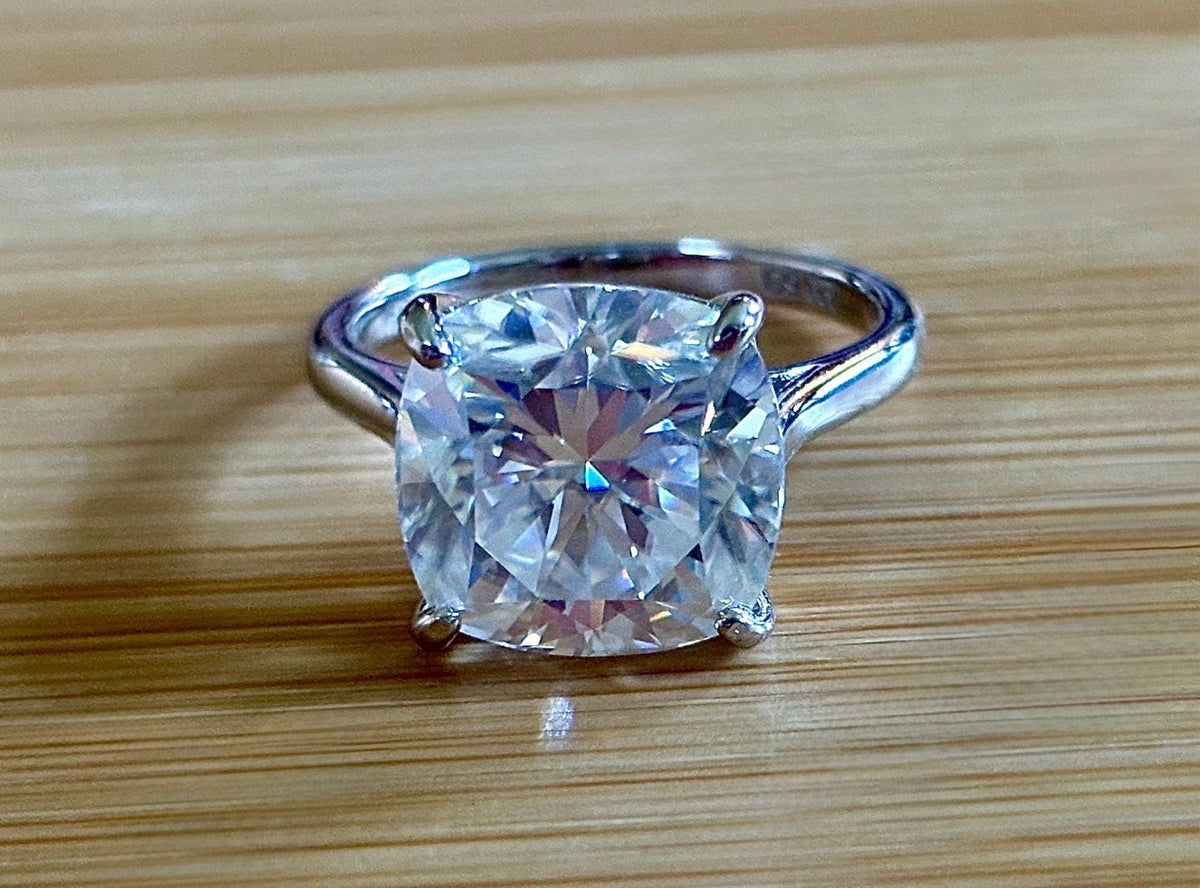 A fiery 9ct certified CLASSIC cushion-cut Moissanite solitaire, the ring of a certain princess (ex-princess?), but without the royal price tag! So indulge!