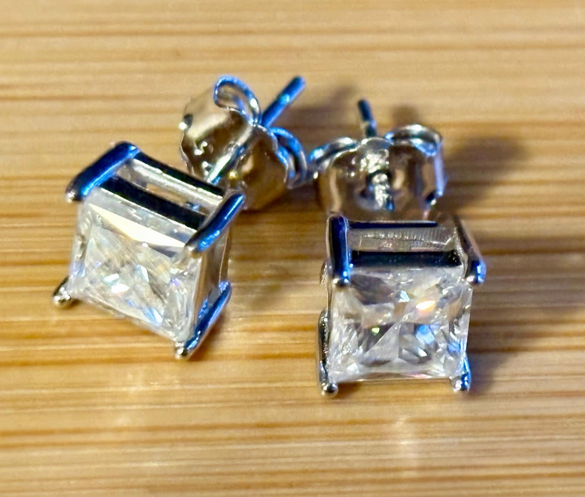 Moissanite studs. A perfect certified pair of 2cttw princess-cut Moissanites in solid sterling silver and 18k white rhodium!