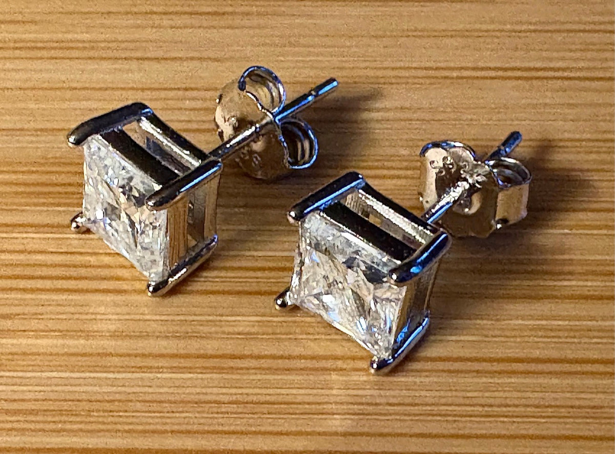 Moissanite studs. A perfect certified pair of 2cttw princess-cut Moissanites in solid sterling silver and 18k white rhodium!