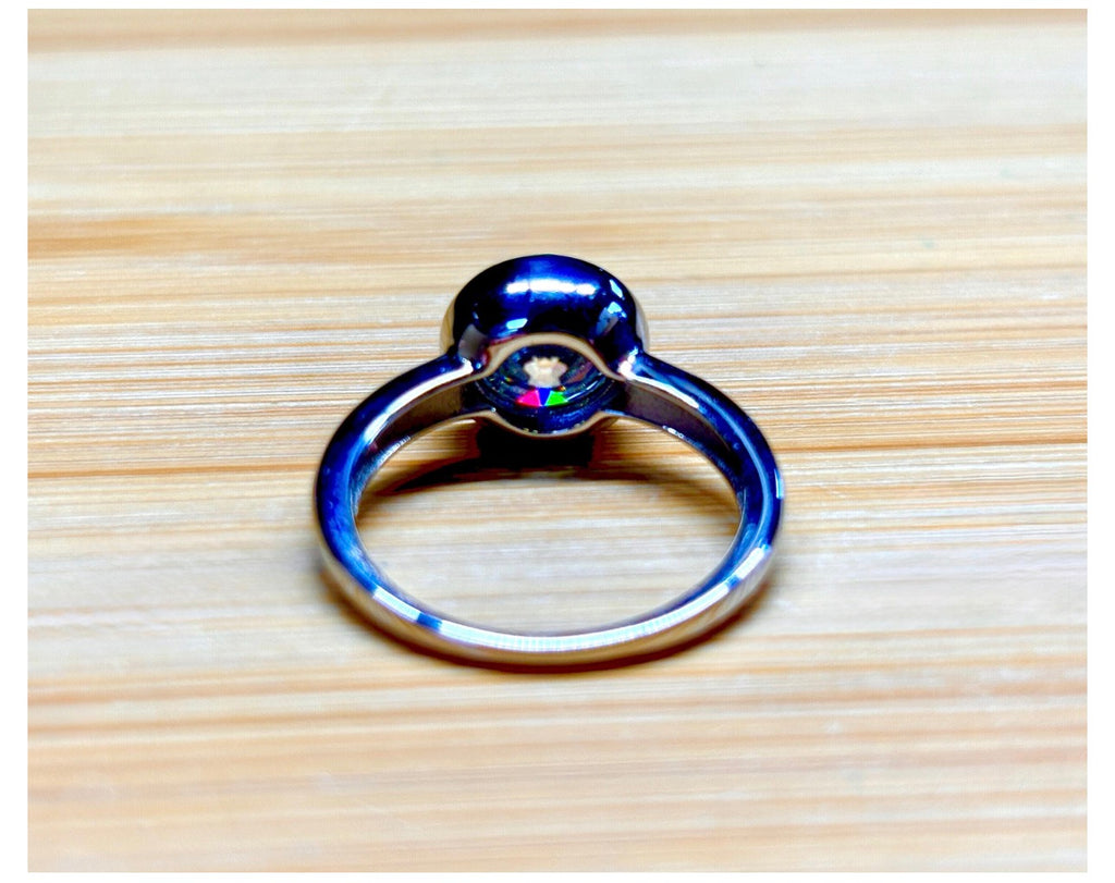 Moissanite solitaire. A 3ct certified round brilliant Moissanite in a weighty solid sterling silver bezel mounting with Seiko-electroplated 18k! A sleek, minimalist design!
