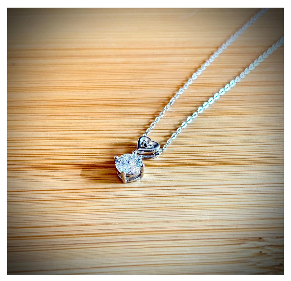 Moissanite necklace. A romantic heart-shaped pendant featuring a certified 1ct round WHITE or BLUE round brilliant Moissanite in sterling silver!