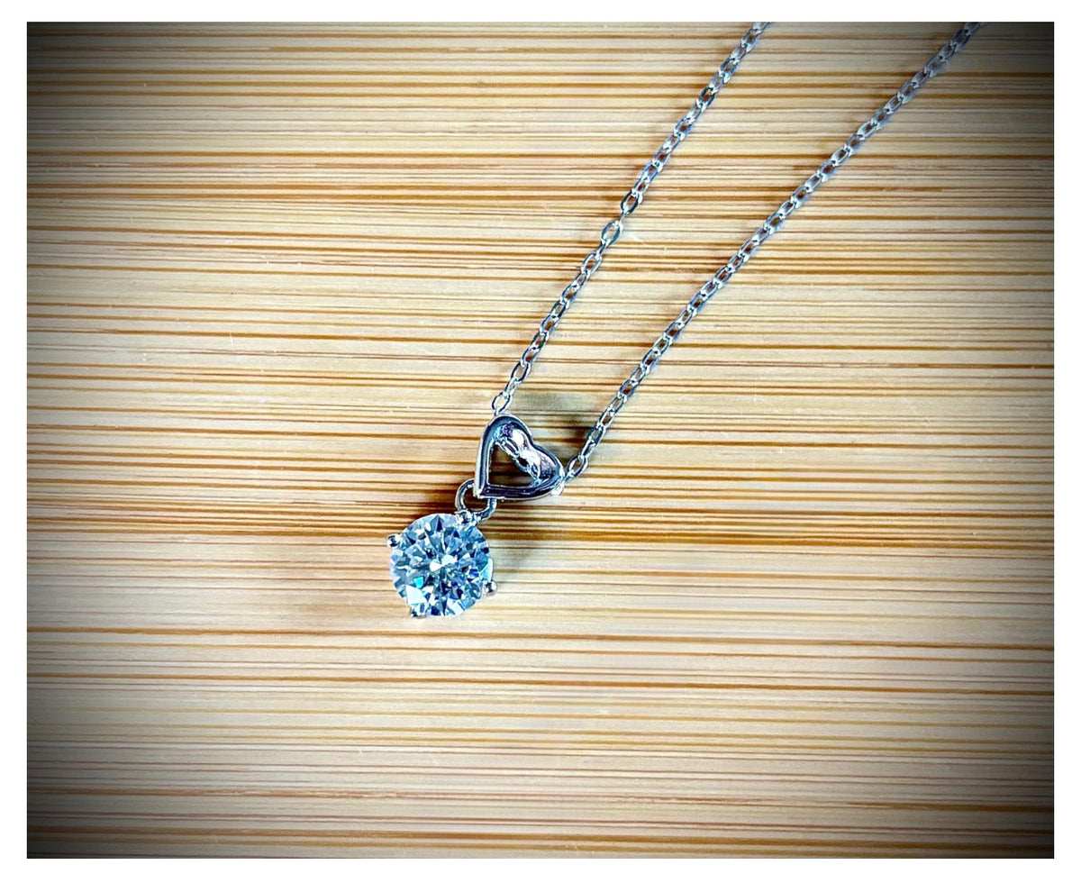 Moissanite necklace. A romantic heart-shaped pendant featuring a certified 1ct round WHITE or BLUE round brilliant Moissanite in sterling silver!