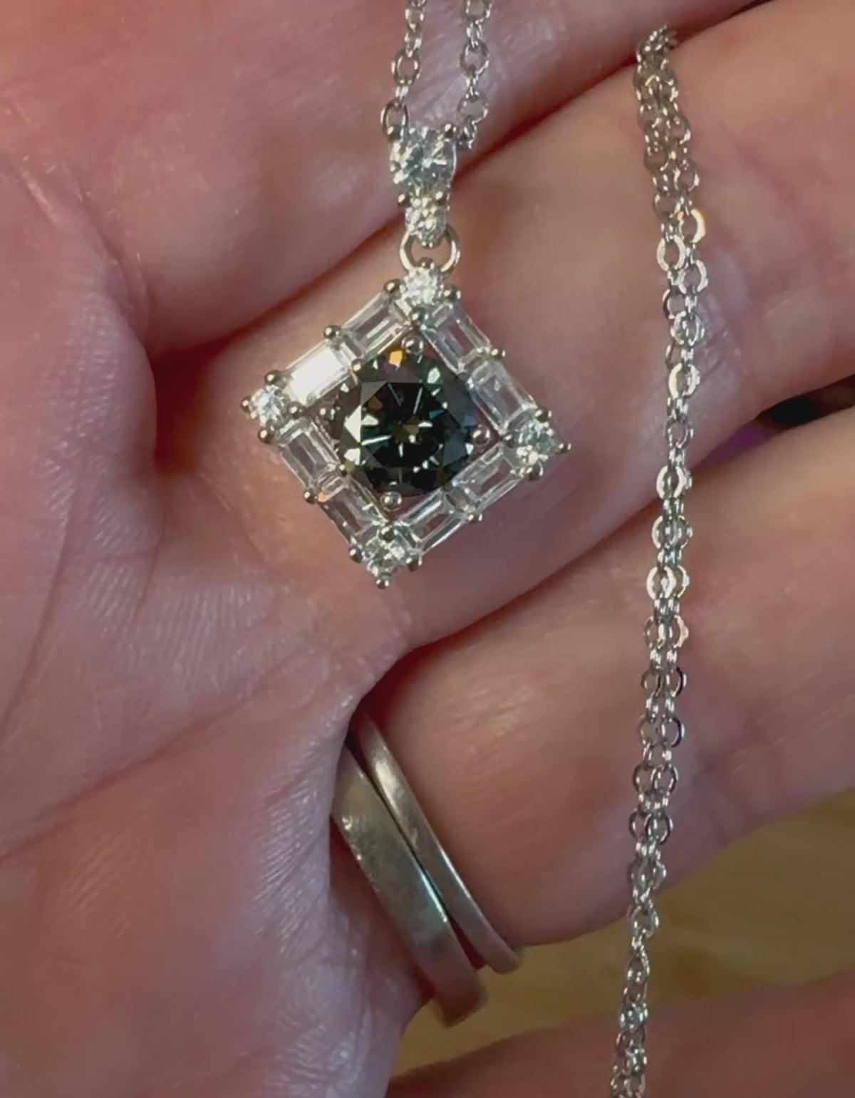 Moissanite necklace. A transfixingly gray 1ct certified round brilliant Moissanite centered in a halo of white zircons - a 2.25cttw pendant!