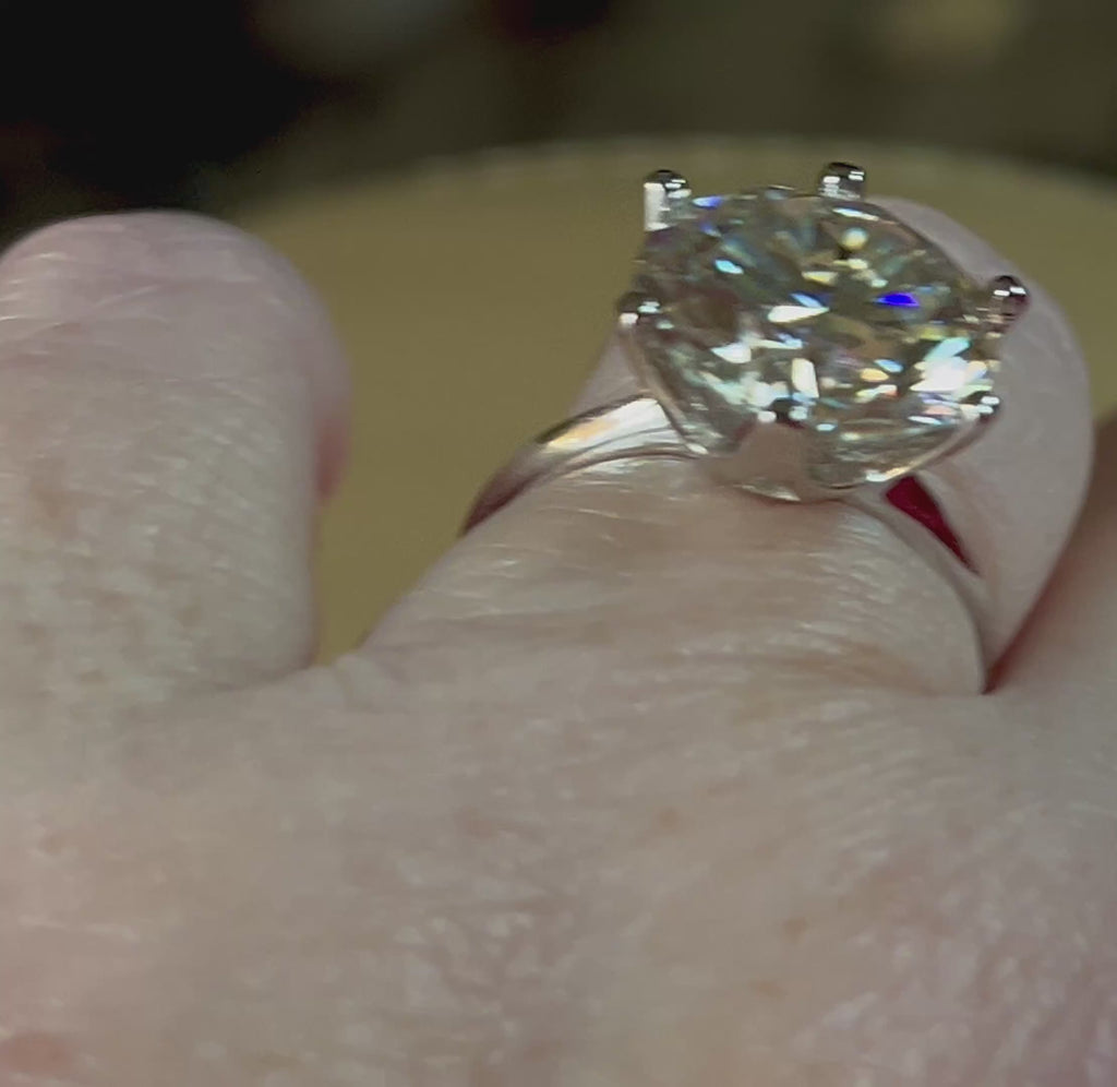 Moissanite ring. A gorgeous 10ct certified round brilliant Moissanite in a lovely crown setting, with 6 prongs and a sleek plain band!