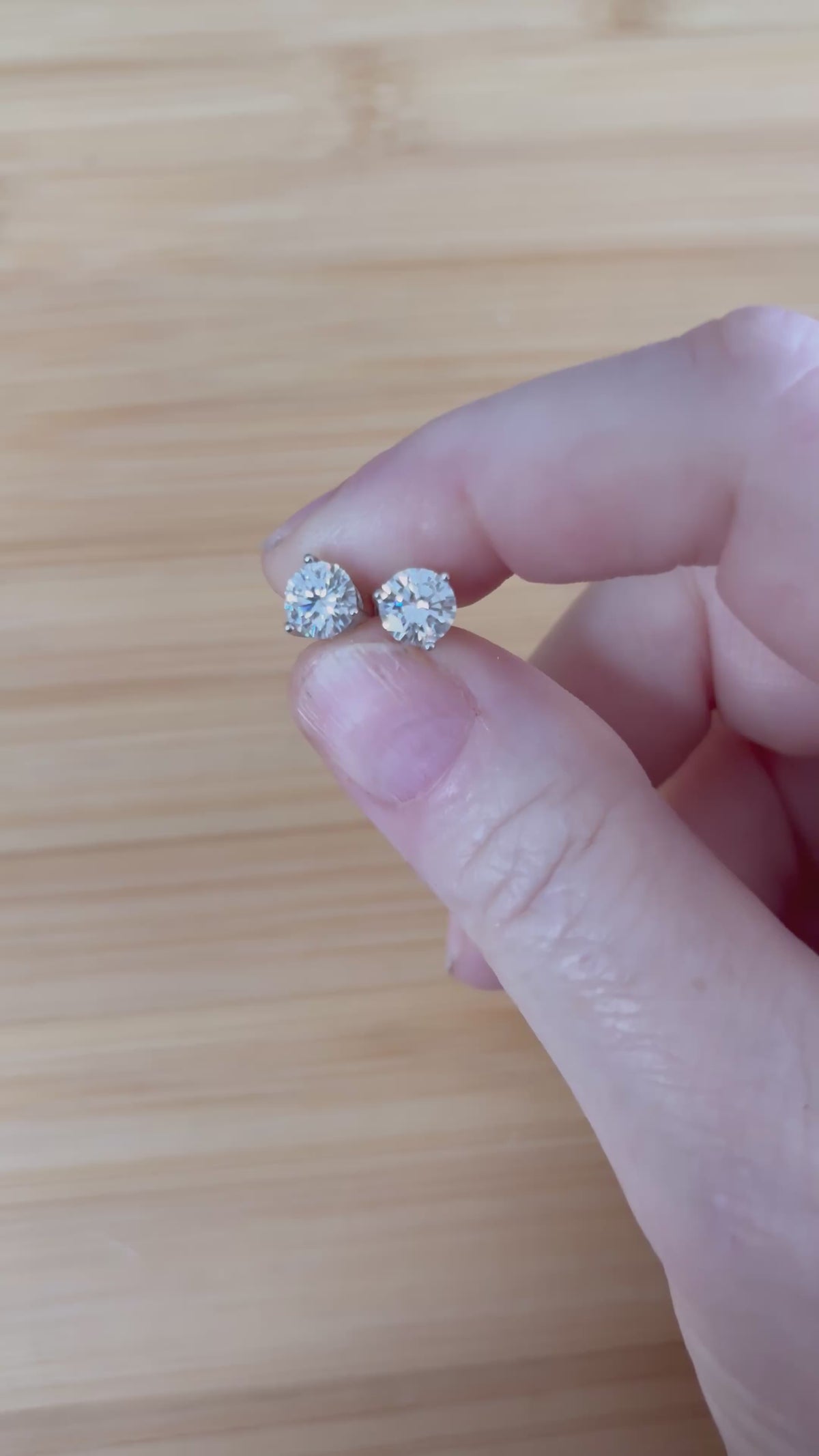 Moissanite earrings. A delicate certified 2cttw pair of 3-prong or 4-prong round brilliant Moissanites in 18k gold-embraced sterling silver baskets! Classic!