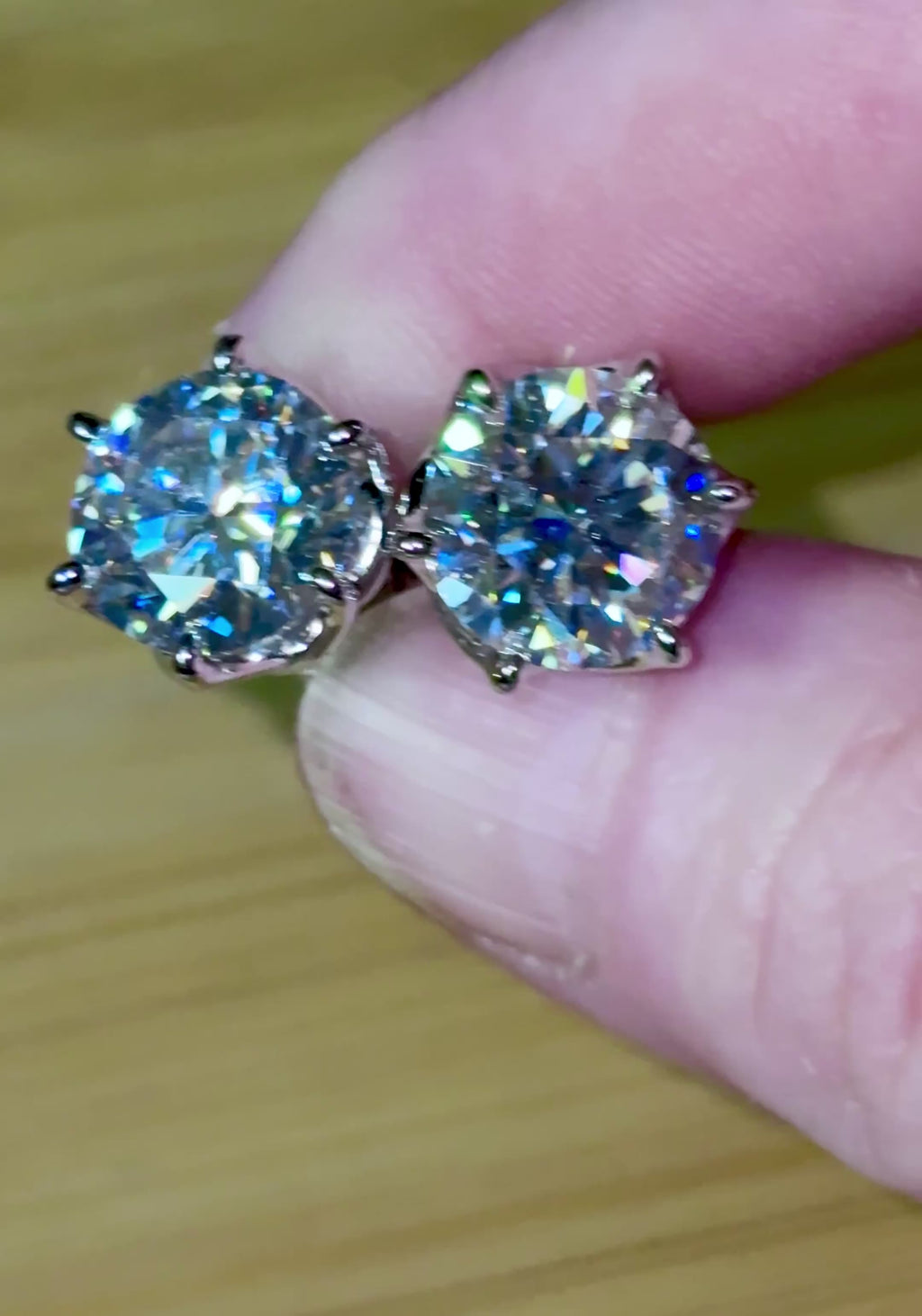 A 10ctw pair of double certified Moissanite studs in lotus-shaped sterling silver baskets!
