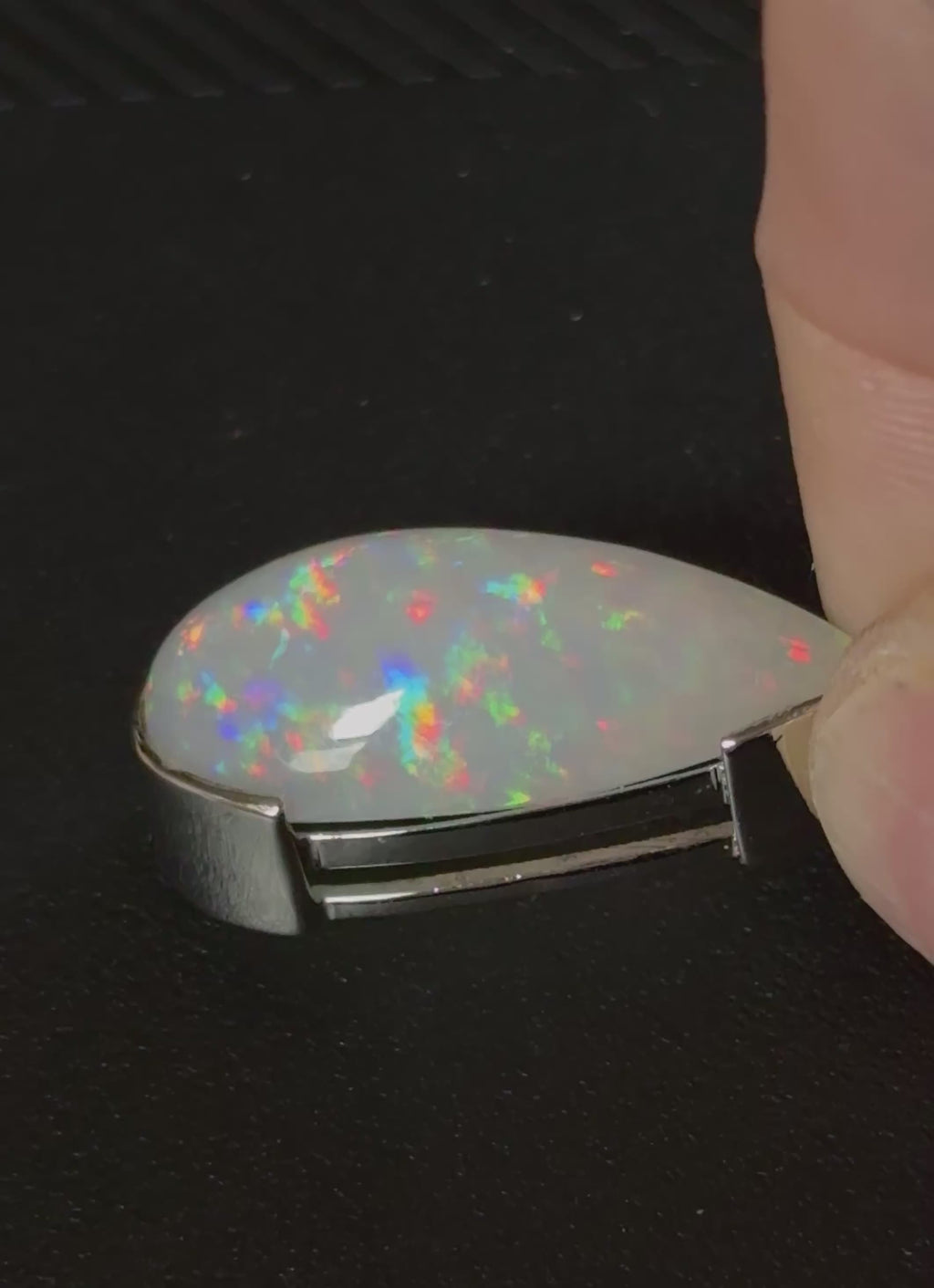 A GORGEOUS 11.05ct AAA+ grade Ethiopian pendant, an elongated pear-shaped cabochon with galaxy pattern fire and phenomenal play of color!