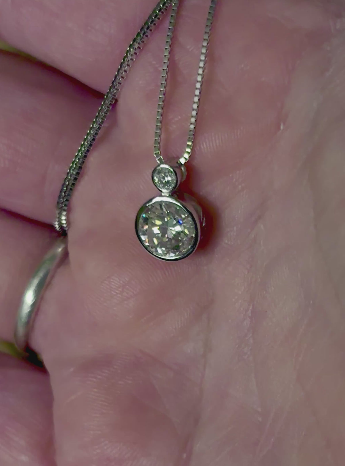 Moissanite necklace. A bright 2.1ctw certified Moissanite bezel pendant, with a 18” box chain and lobster claw clasp in sterling silver!