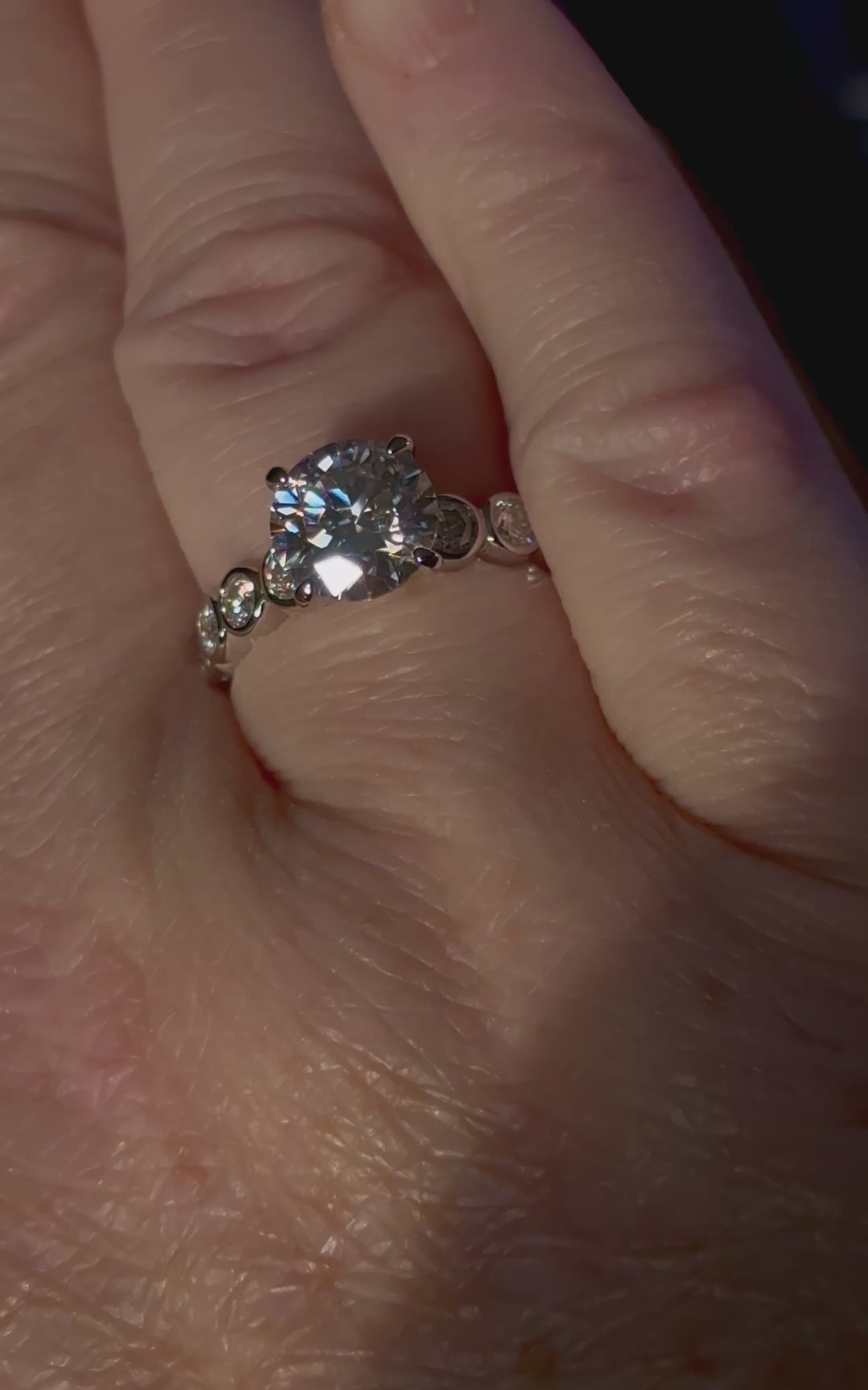 A 3.8cttw designer Moissanite ring with a certified 3ct center stone and 10-point bezel-set stones in sterling silver and 18k gold!