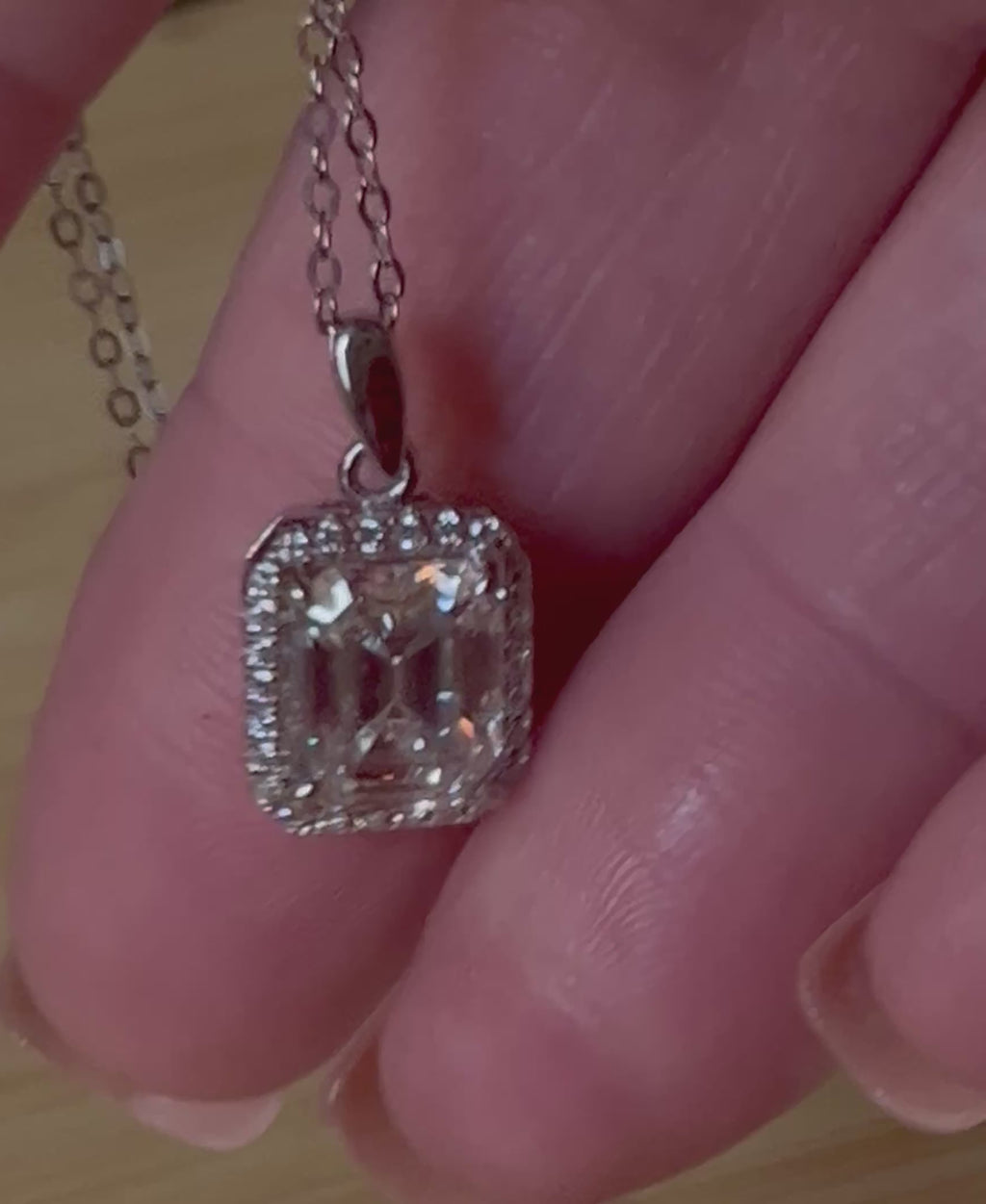 Moissanite necklace. An elegant 3ct certified emerald-cut Moissanite within a halo of shining white zircons, in 18k gold-embraced sterling!